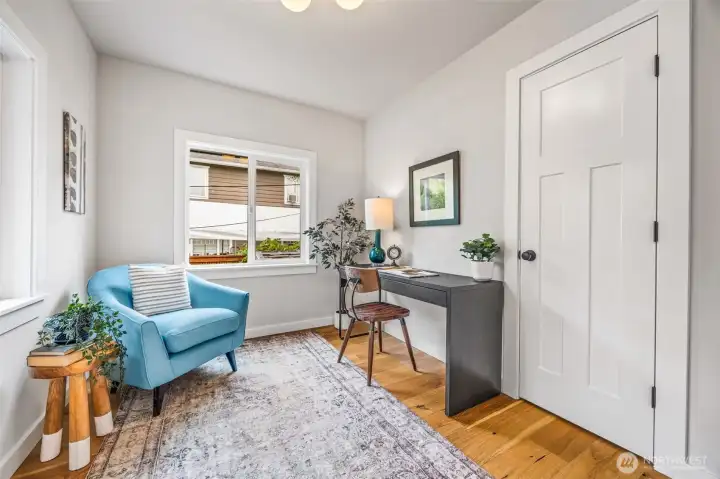 Sunny office space off main living area with closet for additional storage.