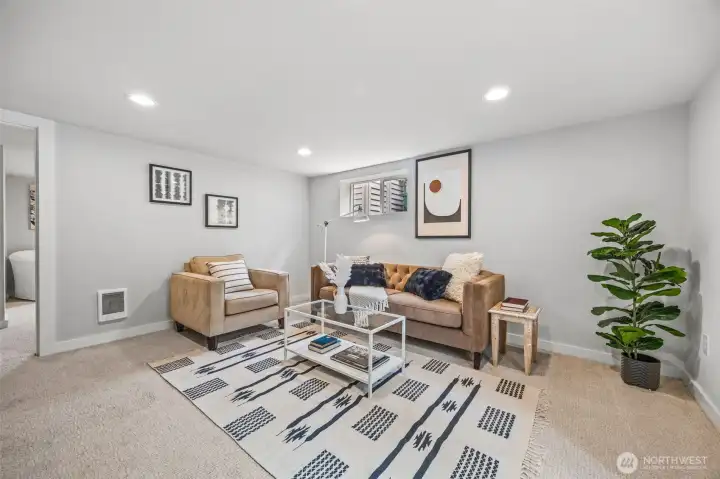 Additional media/recreation room located on lower floor with access to full-fenced backyard.