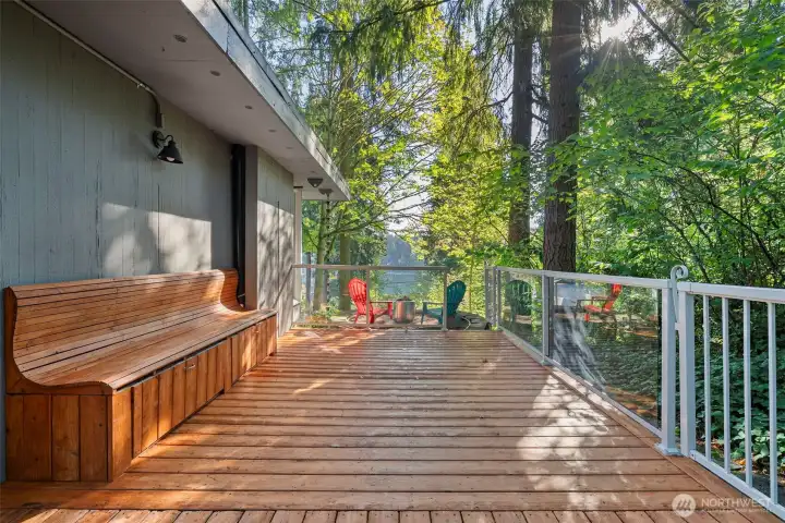 Deck wraps around back of home, fire pit seating area faces Lake Louise