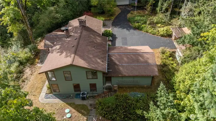 Back of the garage, you will find the heat pump, septic system and there is a fenced off area for a garden. On the other side of the garage there is an outbuilding for lawn tools and there is also a separate wood shed.