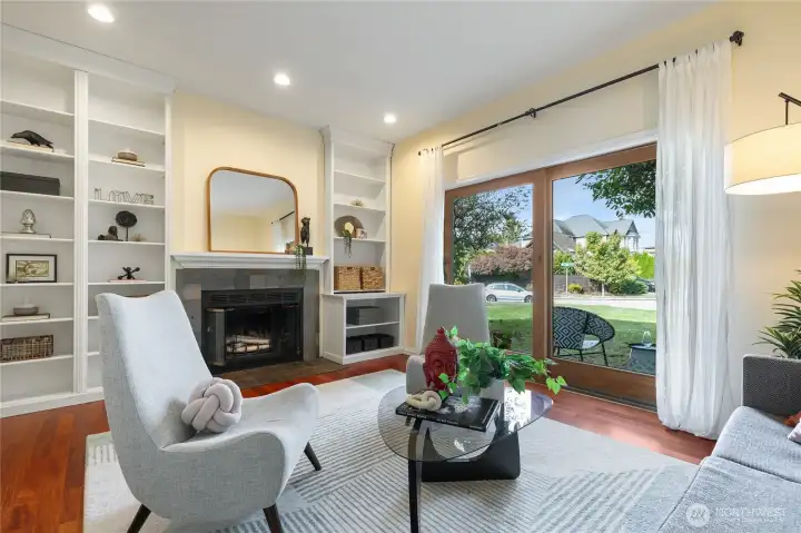 Split level lower living room with cozy fireplace and sliders to back patio