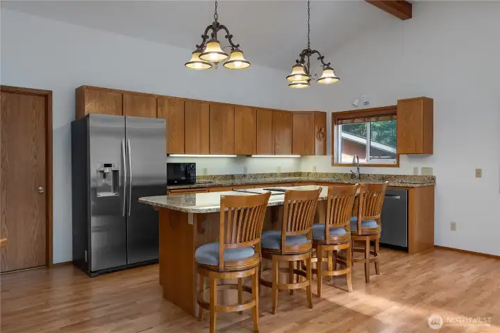 Wood floors, granite countertops, and stainless steel appliances