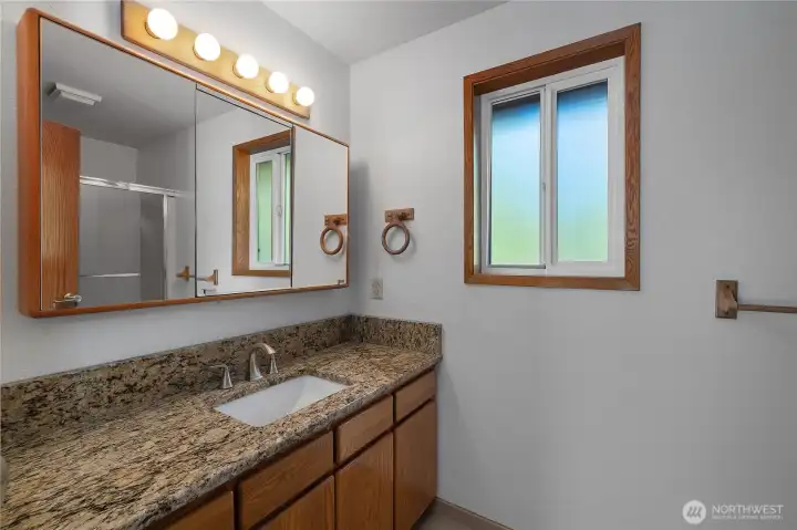 Main floor hallway bath. Full tub & shower and toilet to the right.