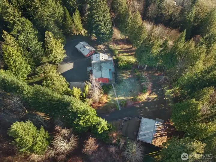 Aerial view of the home, 3-car garage, and shop/ barn