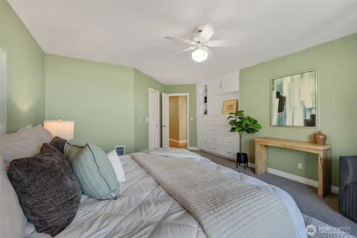 A wall of built-in drawers and closet storage.