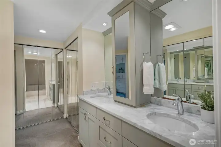 The primary bathroom has multiple closets, a double sink with marble top and built-ins.