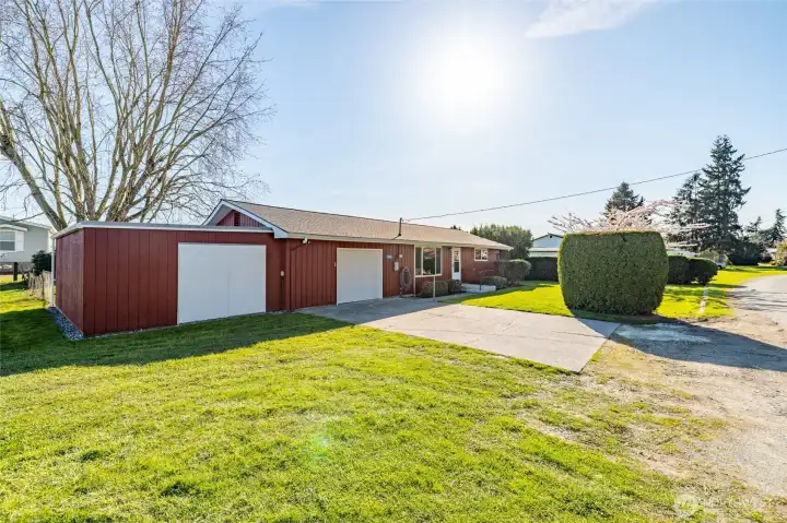 Single car garage with attached workshop building.