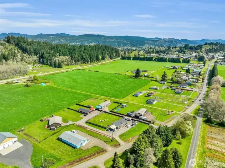 Privacy screens line the driveway and the fence line.