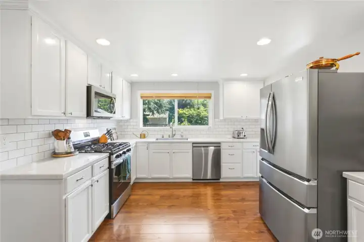 Spacious kitchen with gas range, subway tile backsplash, and a functional layout ideal for cooking and entertaining.