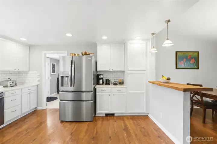 Open flow from the kitchen into the dining area with breakfast bar seating, perfect for everyday living.