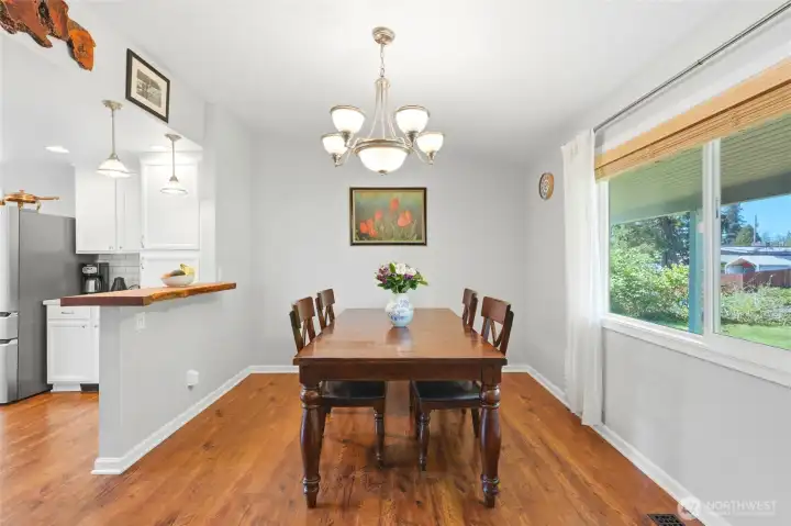 Light filled dining area with large window views and direct access to the kitchen for easy entertaining.