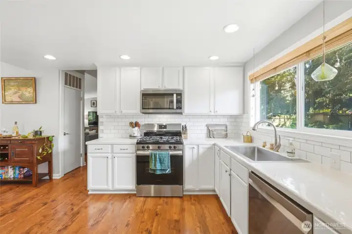 Well appointed kitchen featuring stainless gas range, ample counter space, and clean modern finishes.