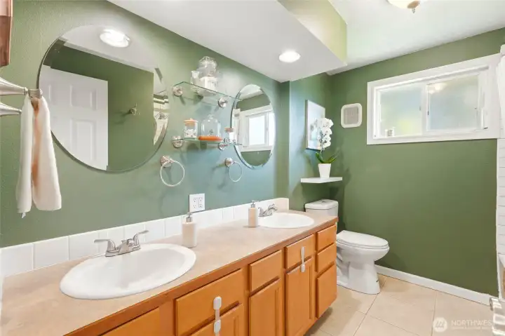 Updated bathroom with rare double vanity, ample counter space, and clean, functional design.