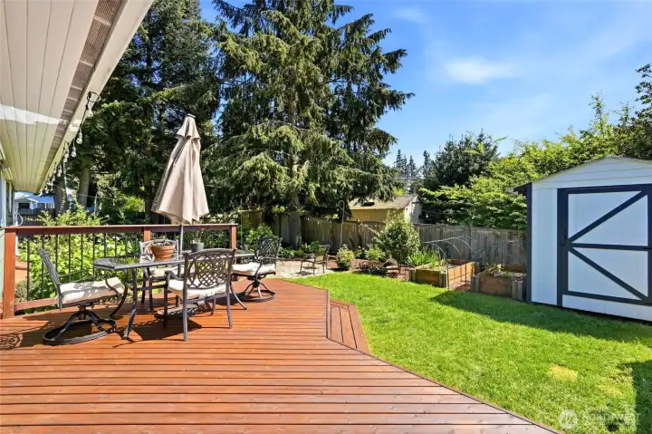 Expansive deck perfect for outdoor dining, entertaining, and enjoying the fully fenced backyard.