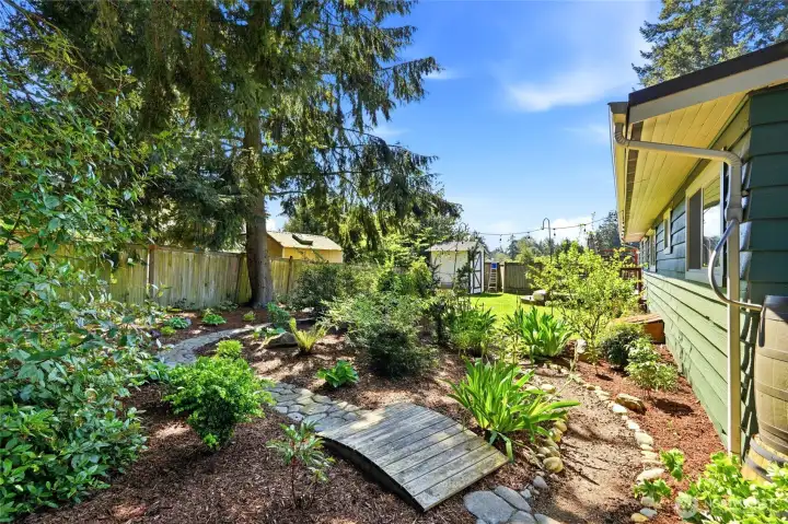 Thoughtfully designed garden beds and pathways create a private and serene outdoor experience.