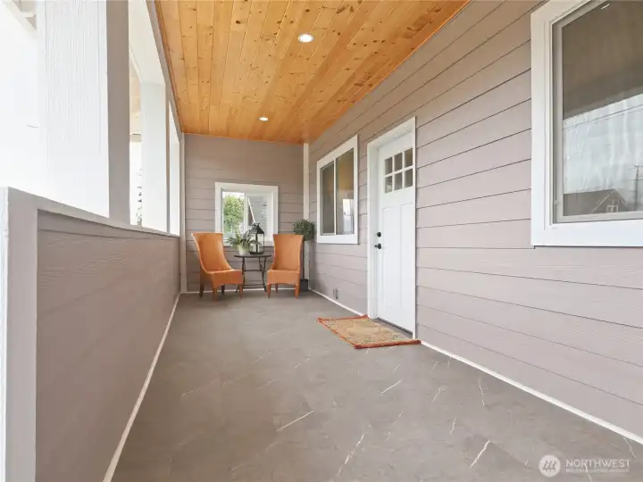 Spacious and inviting covered fromnt porch with view of the neighborhood