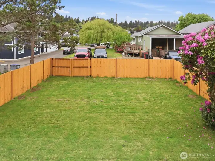 Fully fenced expansive backyard featuring convenient pull-in access. A blank canvas with endless potential for a custom garden, storage shed, or an extended outdoor living oasis.