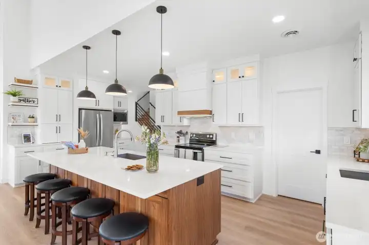 Vaulted kitchen with Painted White and Natural Walnut Cabinetry with Quartz Counter tops, Polished marble tile backsplash.