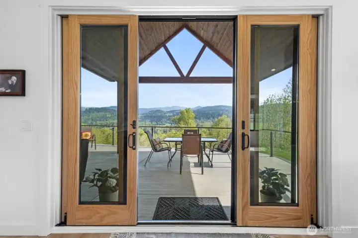 Doors to the patio. View from the living room out. Timber truss covered open side patio.  Sit on the porch and enjoy the mountain and territorial views.