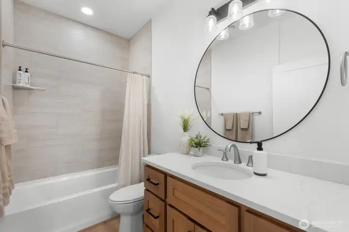 Main Floor Guest bathroom with tiled shower and a soaking tub.