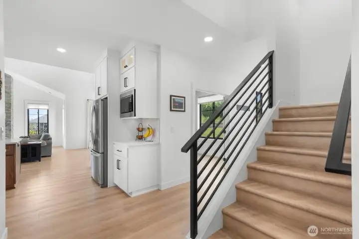 Stairway to upper floor bonus room and 3/4 bath.