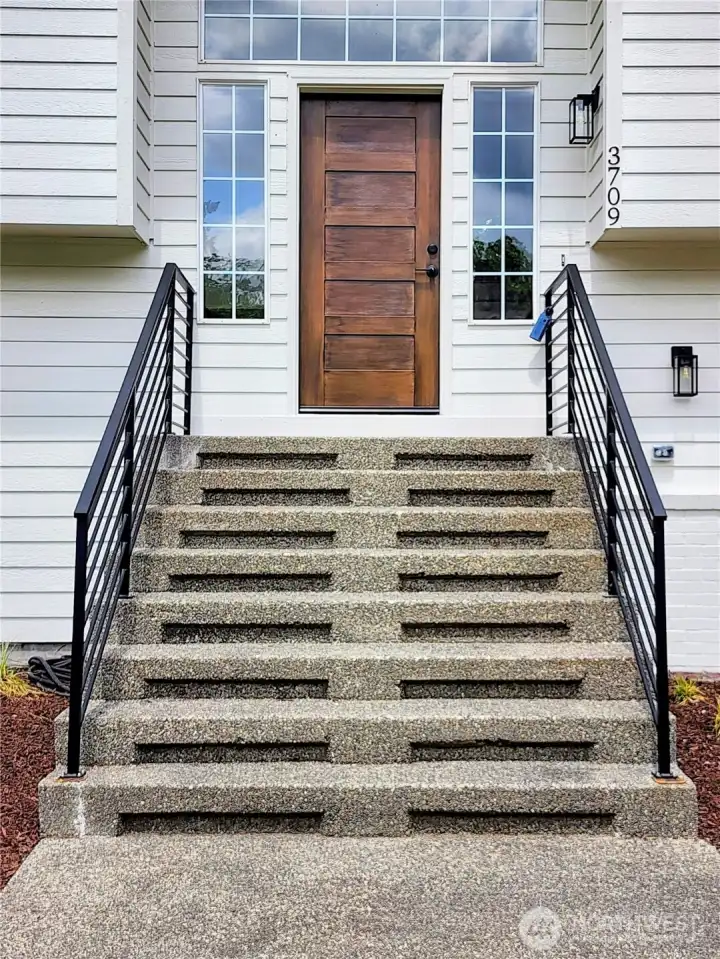 Grand entry with custom powder-coated railing.