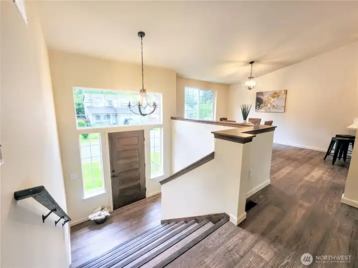 Spacious and light-filled foyer with grand, wide steps up.