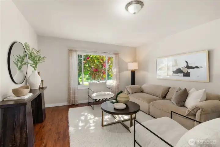 Living room is cozy and perfect for relaxing. This is facing east, so you'll have morning sunlight to look forward to!