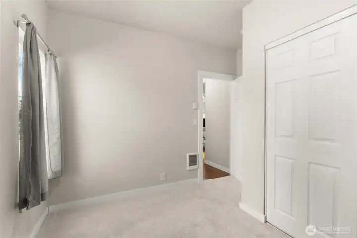 Second bedroom on the main floor, located right off the living room. Second full bathroom is right outside this door.