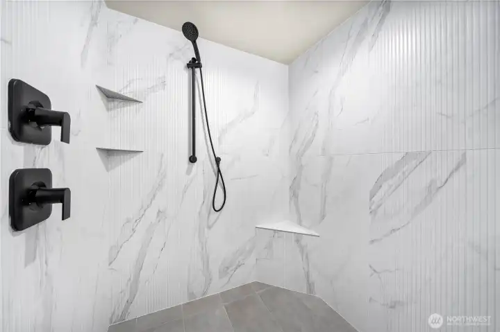 Oversized shower with bench-recirculating hot water for immediate showers