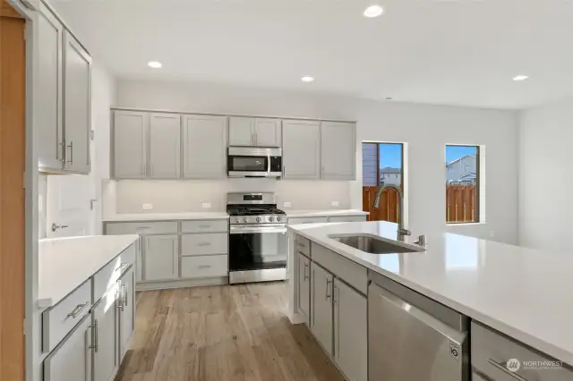 Large kitchen with door to garage. Images used for representation only.