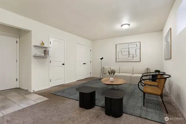 Lower level family room has a 1/2 bathroom, laundry closet with full washer and dryer and office nook.   Virtually staged photo.