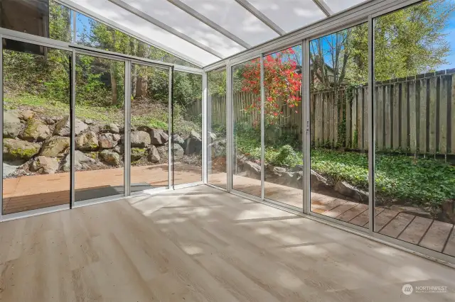 Sun room off the dining room with doors to back deck.