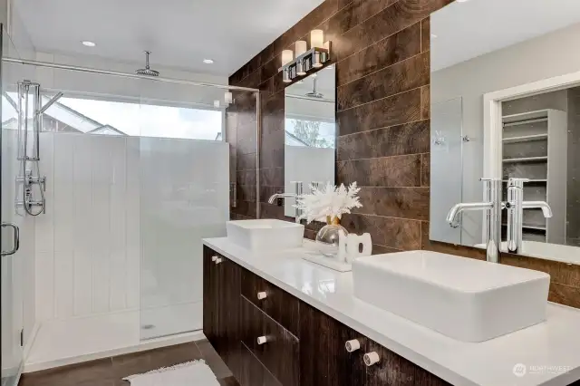 Primary bathroom with double vanity, quartz counters, and generous shower.