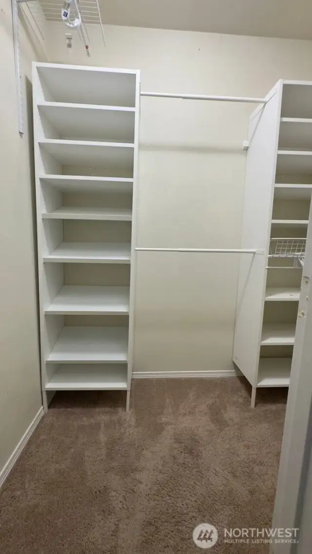 Primary bedroom walk in closet