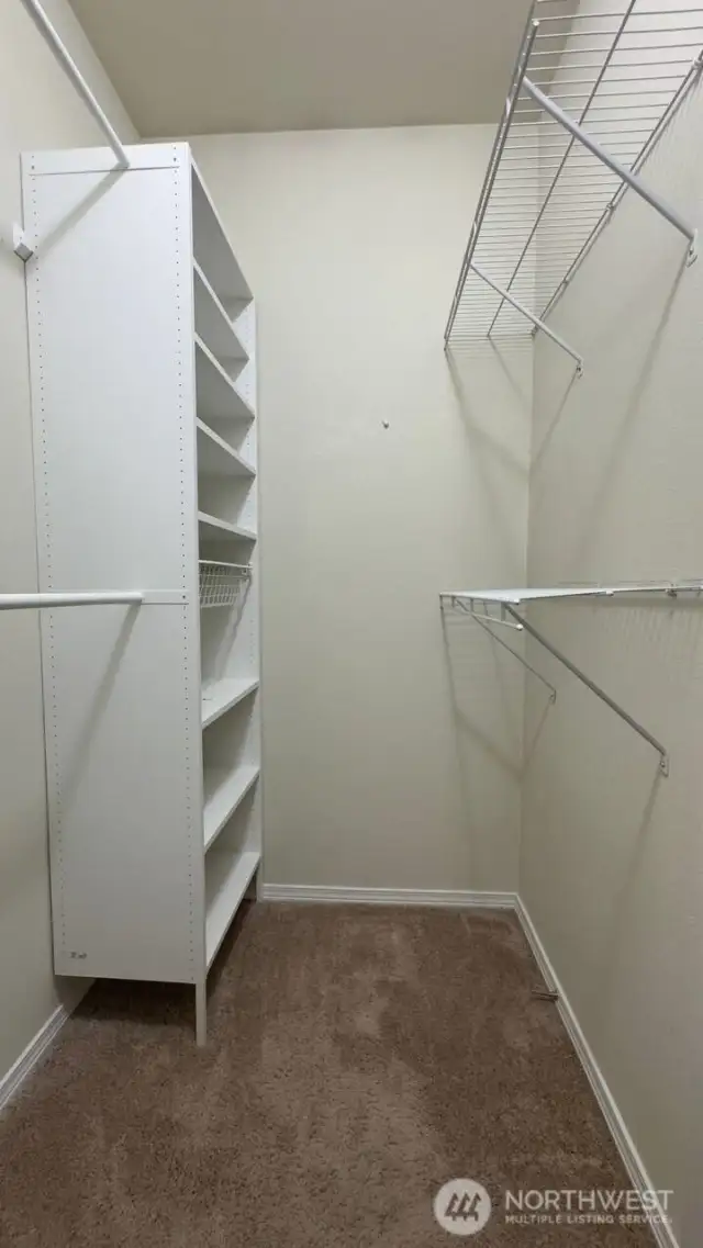 Primary bedroom walk in closet