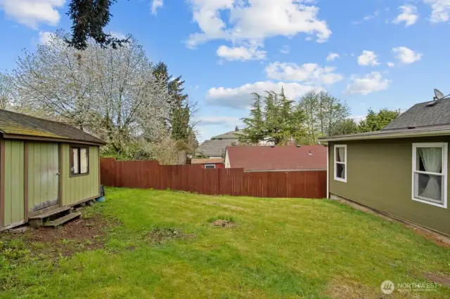Spacious back yard with large storage shed