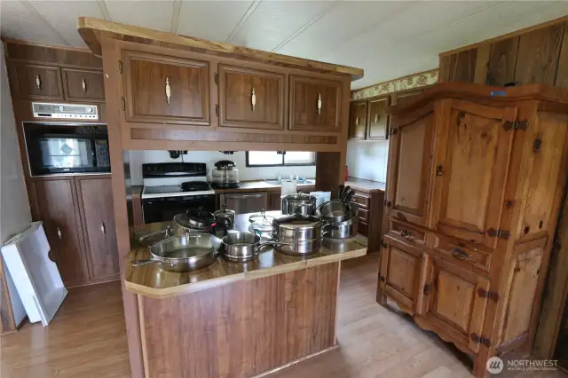 Kitchen island with built-in eating space and upper cabinets for added storage.