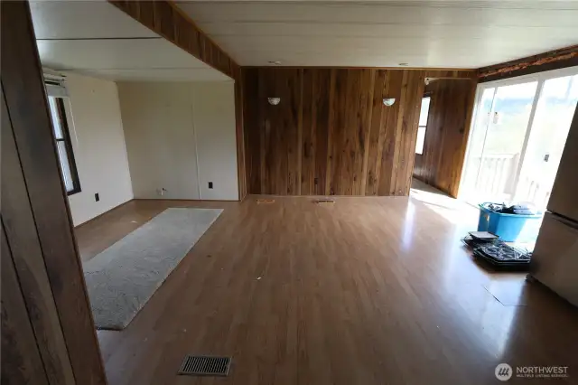 Spacious family room with sliding door access to the level yard—perfect for outdoor enjoyment. With a little TLC, this home has the potential to truly shine again.