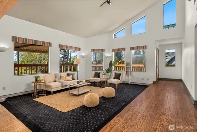 The recently refreshed hardwood floors surround the open concept living room with high vaulted ceilings.