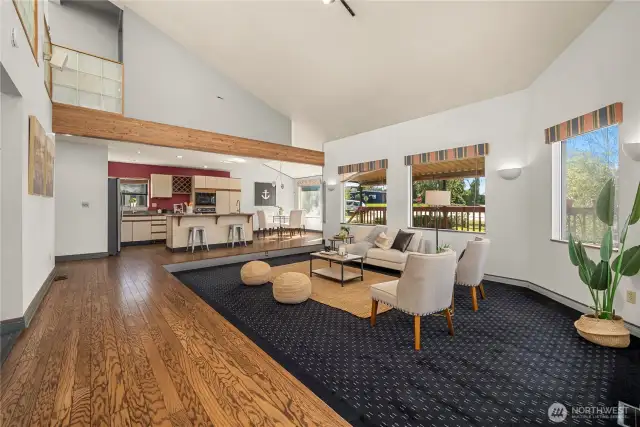 This view shows the spacious great room complete with living room, kitchen and eating area.
