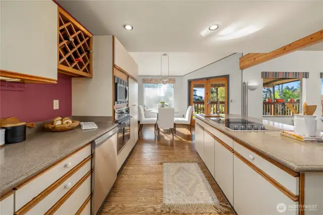 Abundant kitchen counter and cupboard space including a wine rack.