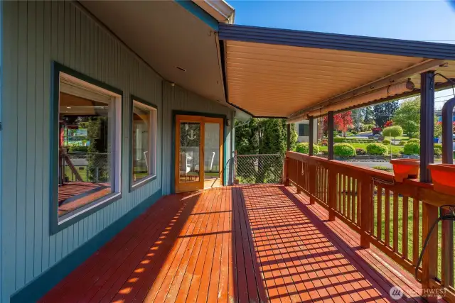 French doors open to the covered wrap around deck that faces the sunset and provides enjoyment in any weather.