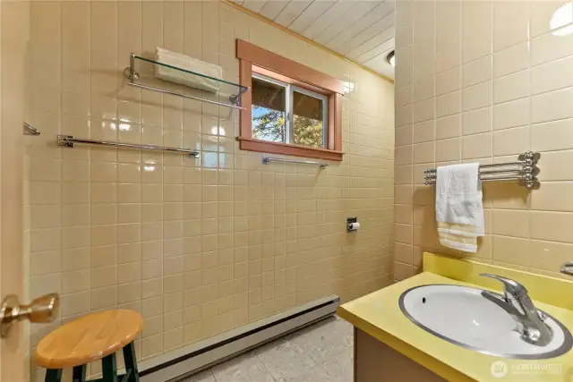 Main floor includes a full bathroom with classic finishes—conveniently located near both bedrooms and living areas.