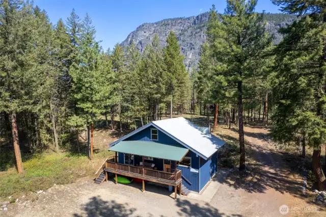 Private Riverfront Retreat  Nestled on 5 forested acres with over 500 feet of Methow River frontage, this charming vintage cabin offers unmatched seclusion, filtered mountain views, and the timeless beauty of Mazama living.
