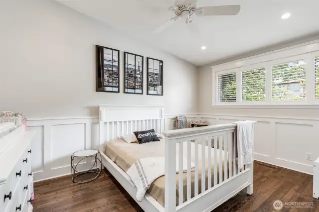 Second bedroom on the main floor with beautiful wainscoting, custom closet and shutters.