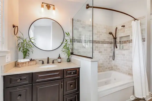 Full bath on the main floor with heated floors and spa bathtub.