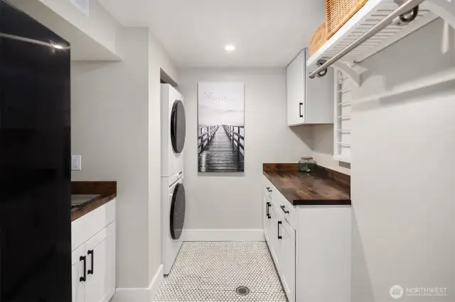 Utility room that checks all the boxes!  Samsung full size refrigerator and stacked washer and dryer, utility and drying rack.  They thought of everything!