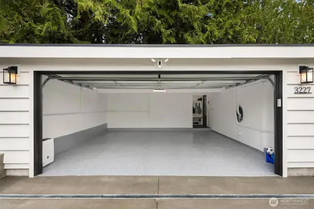 Spacious two car garage, new epoxy floors, glass garage door, Tesla charger and a wonderful mud room drop off space before entering the house.