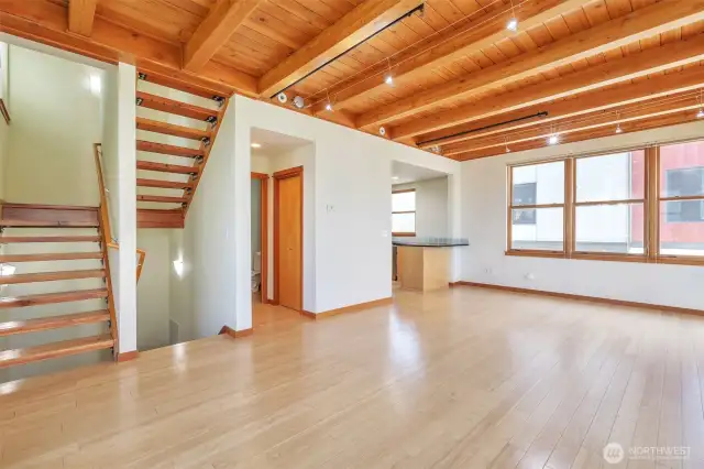 Light-filled and airy interior design with spacious living areas.  Beautiful exposed wood beam ceiling and open, reclaimed wood staircase.